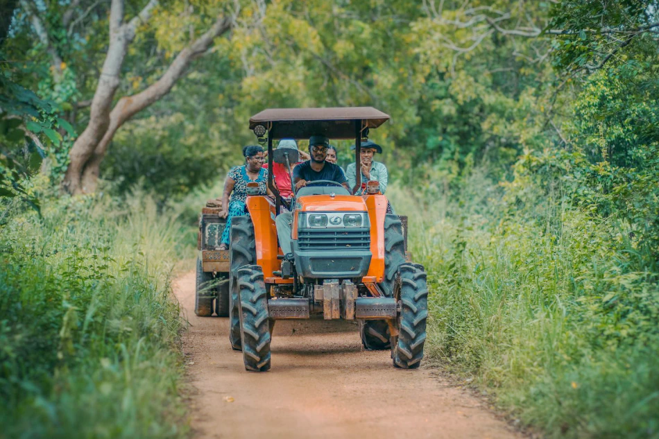 Image of a family riding a tractor in a rural area